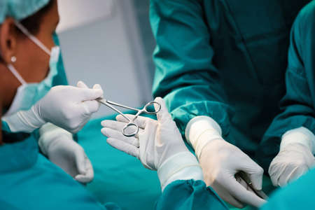 Surgery team operating in a surgical roomの写真素材