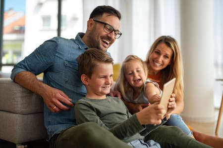 Happy family having fun and spending time together at homeの写真素材