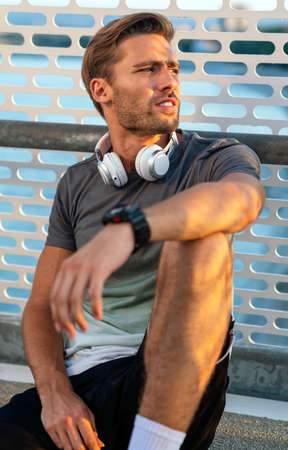 Fitness sport people lifestyle concept. Portrait of young man running to stay healthy outdoors.