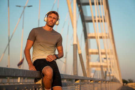 Young fit man take a little break after training outdoor. Fitness sport people lifestyle conceptの写真素材