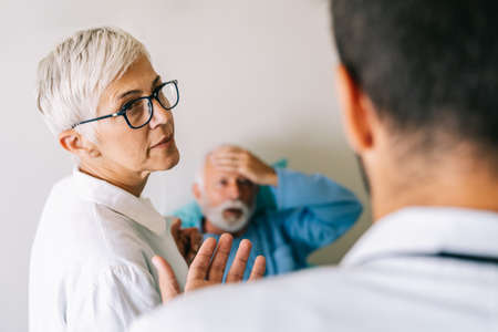 Doctor discusses the diagnosis with the worried senior man patient. Healthcare conceptの写真素材