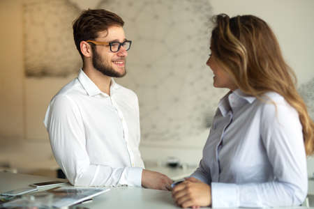 Two young colleagues chatting together on a breakの写真素材