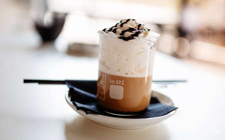 Delicious coffee with whipped cream in a glassの写真素材