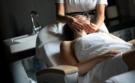Young beautiful female in beauty salon getting spa massageの写真素材