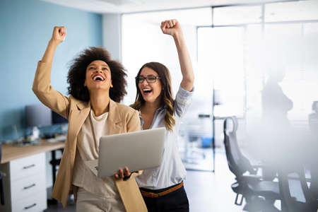 Happy multiethnic smiling business women working together in officeの写真素材