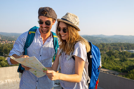 Happy tourist couple, friends sightseeing city with map. Travel people vacation concept