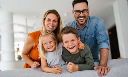 Happy family having fun and spending time together at homeの写真素材