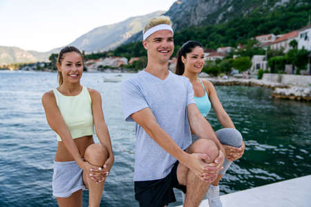 Group of friends fitness training together outdoors living active healthyの写真素材