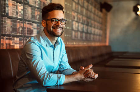 Portrait of happy successful businessman. Satisfied man feeling confident in a creative office.の写真素材