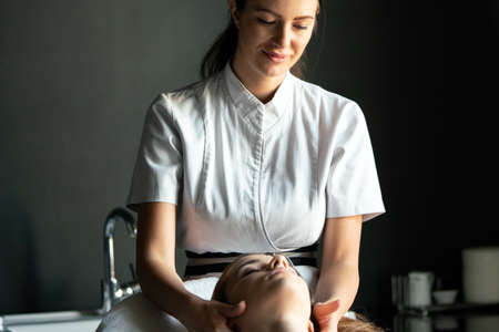 Healthy woman having massage therapy at spa salonの写真素材