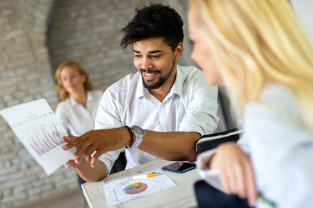 Group of happy multiethnic business people cooperating, working on meeting in corporate officeの写真素材