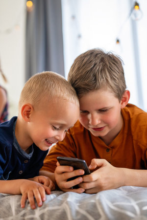 Portrait of happy children using digital devices and having fun together.