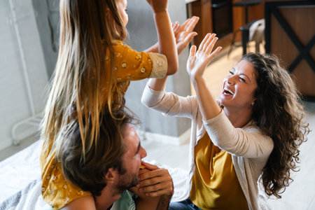 Family holiday and togetherness. Happy parents spendig fun time, playing with child.の写真素材