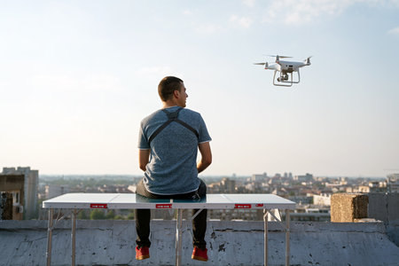 Man with drone flying at the city