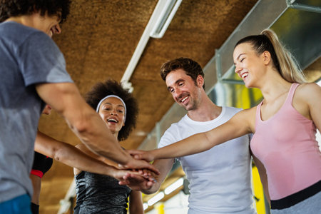 Fitness, sport, people and lifestyle concept. Group of smiling people exercising together in gym