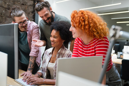 Smiling diverse colleagues gather in boardroom brainstorm discuss financial statistics togetherの写真素材