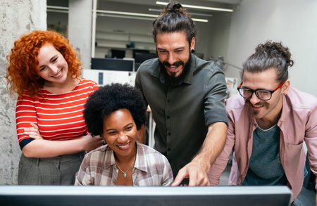 Smiling diverse colleagues gather in boardroom brainstorm discuss financial statistics togetherの写真素材