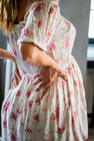 Pregnant woman suffering during her pregnancy, with back pain and headaches.の写真素材