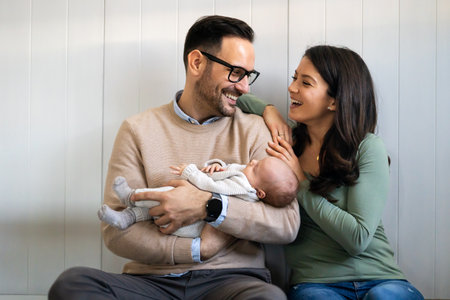Portrait of parents and newborn baby. Father and mother kiss and hug a beautiful newborn child. .