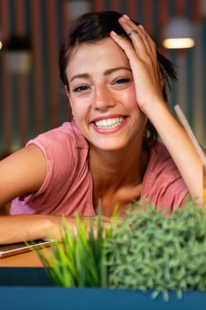 Portrait of happy woman smiling with perfect smile and looking at cameraの写真素材