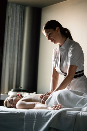 Young beautiful female in beauty salon getting spa massageの写真素材
