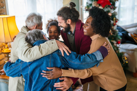 Cheerful extended multiethnic family having fun while celebrating Christmas together at home.の写真素材