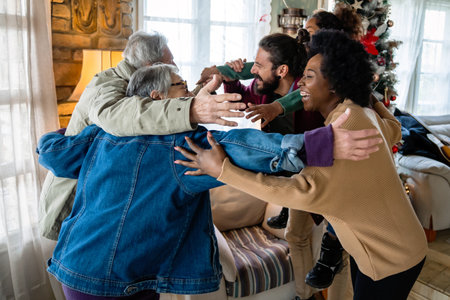 Excited multiethnic family greeting grandparents on Christmas Day. Multi-generational happy family