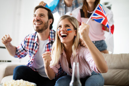 Excited fans of soccer friends celebrating winning matchの写真素材