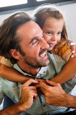 Fathers day. Happy family daughter hugging dad and laughs on holidayの写真素材