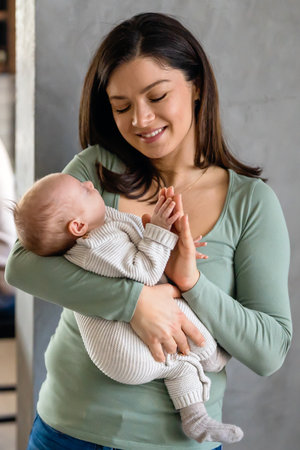 Family, motherhood, parenting, people baby and child care concept. Happy mother with adorable baby