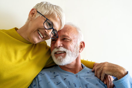 Elderly couple in love. Senior husband and wife hugging and bonding with true emotionsの写真素材