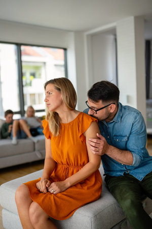 Sad pensive couple thinking of relationships problems sitting on sofa, conflicts in marriage.の写真素材