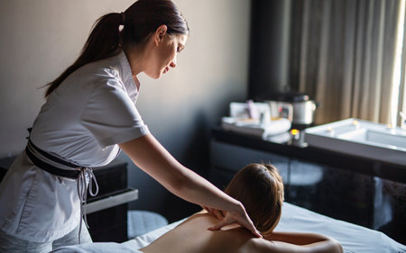 Young happy Caucasian woman relaxing with hand massage at beauty wellness spa salonの写真素材