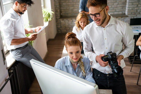 Creative startup young multiethnic business people working together at designer agency in officeの写真素材