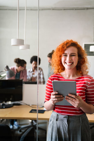 Portrait of young happy success woman working in a busy modern workplace, Startup coworker conceptの写真素材