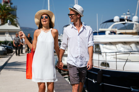 Excited people having fun and shopping. Outdoor shot of a young couple enjoying summer vacationの写真素材