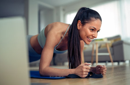 Young flexible girl doing yoga, gymnastics, flexibility and stretching at home in a bright room