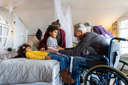 Happy multiethnic diverse family enjoying weekend together at home. Senior people with wheelchair.