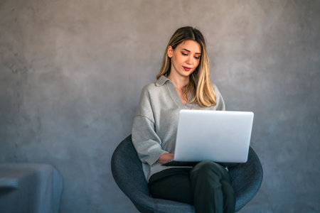 Business woman working on laptop at home office. Remote teacher, remote studying, virtual training.の写真素材