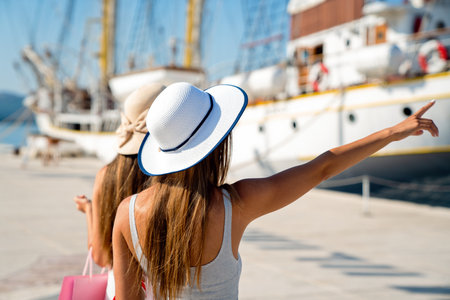 Beautiful woman in hat and sunglasses relaxing on summer vacation. Traveling and yachting concept.の写真素材