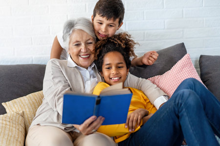 Multiethnic family. Grandparent teaching children to read for school