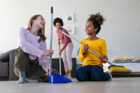 Happy multiethnic children helping for mother do household and domestic chores togetherの写真素材