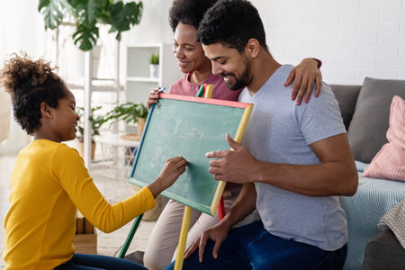 Multiethnic black diverse family teaching child. Home education family conceptの写真素材