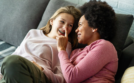 Loving african american foster care parent single mother embrace teen daughterの写真素材