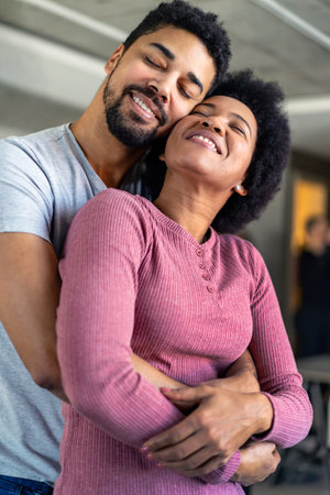 Portrait of happy smiling black couple in love having fun and hugging togetherの写真素材
