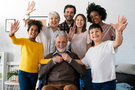 Multi generation, multiethnic family at home together, grandfather with disability