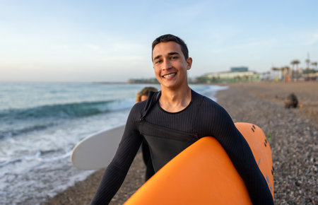Joyful youngoman carrying a surfboard on a beach, his face filled with happiness and excitementの写真素材