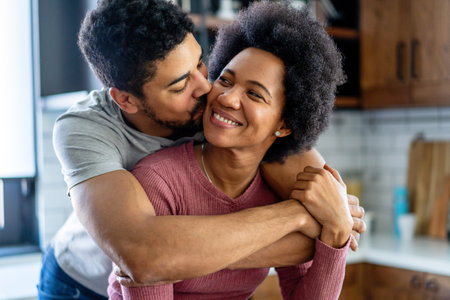 Portrait of happy smiling black couple in love having fun and hugging together