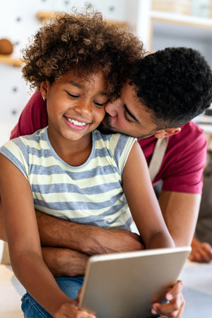 Happy african american single dad spends happy moments with his daughter. Family love conceptの写真素材