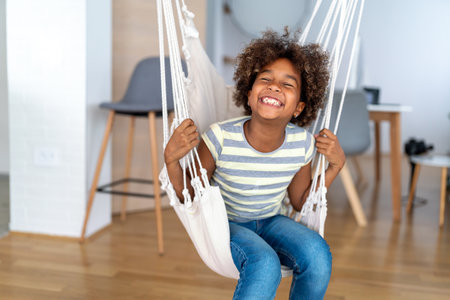 Portrait of happy cute african american preteen little girl at home. Childhood kid children conceptの写真素材
